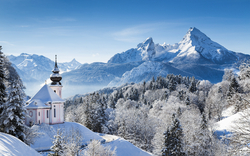 Kirche von Maria Gern vor dem Watzmann im winterlichen Berchtesgadener Land, Bayern, umgeben von verschneiten Alpenlandschaften.