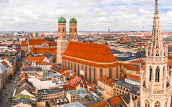 Blick auf München mit Frauenkirche und Neubauten im Vordergrund.