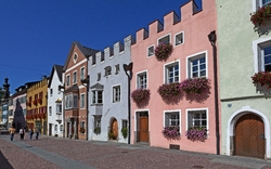 Bunte Häuserreihe mit Blumenkästen in Straßburg bei sonnigem Wetter.