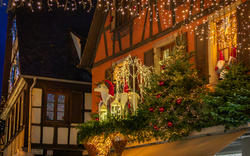Weihnachtlich geschmücktes Fachwerkhaus mit Lichtern und Weihnachtsdekorationen.